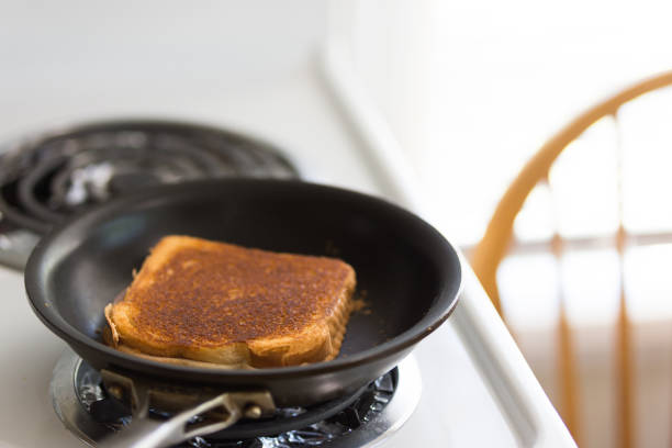 istock Grilled cheese cooking on stove top pan 1186409132