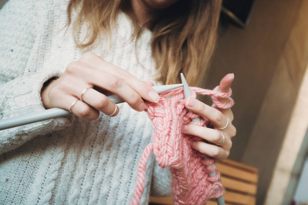 istock Close up on woman's hands knitting 1186414484