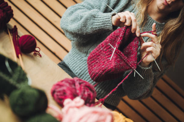 istock Close up on woman's hands knitting 1186414485