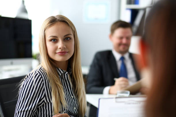 istock Beautiful blonde clerk in office looking in camera 1186414527