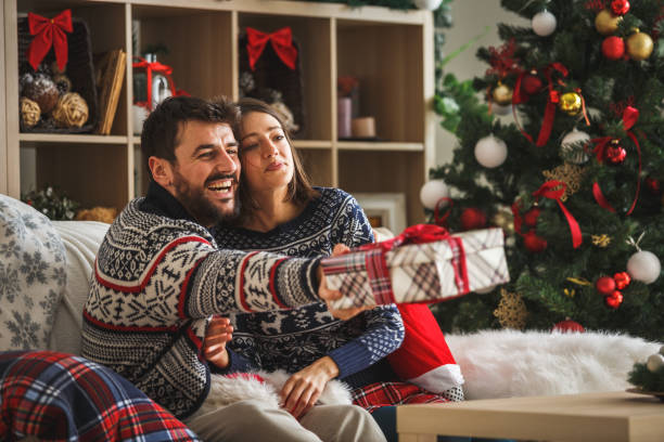 istock Young couple celebrating Christmas together 1186414560
