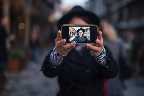 istock Woman with smart phone making selfie. 1186414902