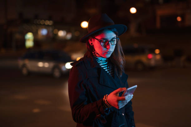 Woman using phone on the street. Woman using phone on the street, she standing on the street in night city. crowdsourced taxi photos stock pictures, royalty-free photos & images