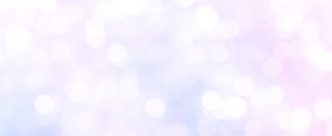 abstract blur beautiful glowing purple and pink pastel color panoramic background with circle bokeh light glittering for christmas festival and happy new year season design as banner concept