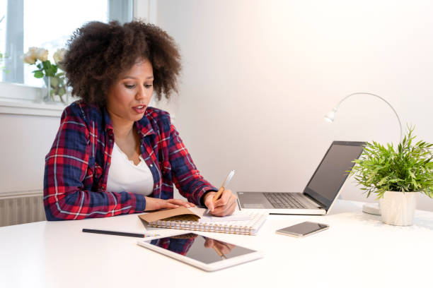 istock Young freelancer working on a laptop in home office 1186415127