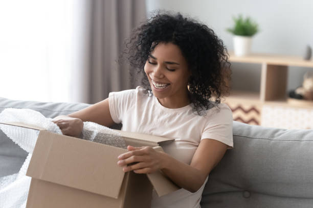istock African woman unpacking cardboard box parcel feels happy 1186418422