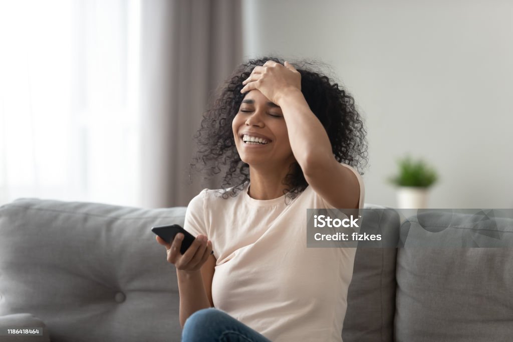 African Woman Laughs At Funny Video Or Joke Prank Online Stock Photo -  Download Image Now - iStock