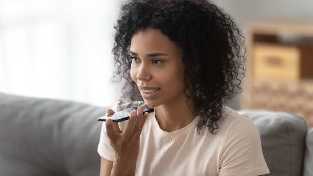 istock African woman speaking using loudspeaker on mobile phone 1186418467