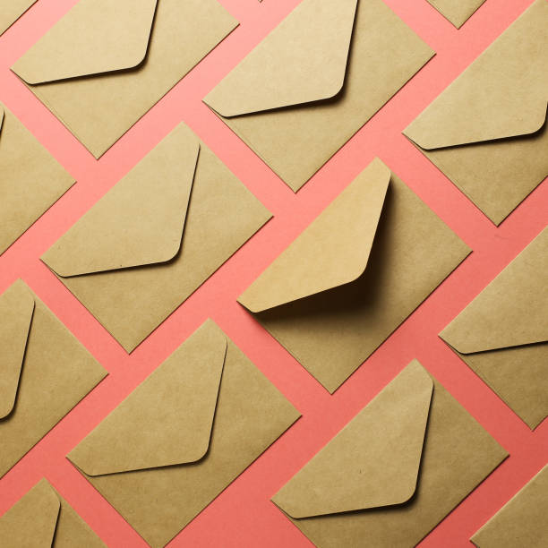 istock Kraft brown paper envelopes on pink background 1186423825