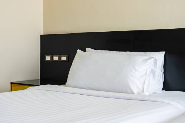 istock Pillow and blanket on bed with light lamp decoration interior 1186428614