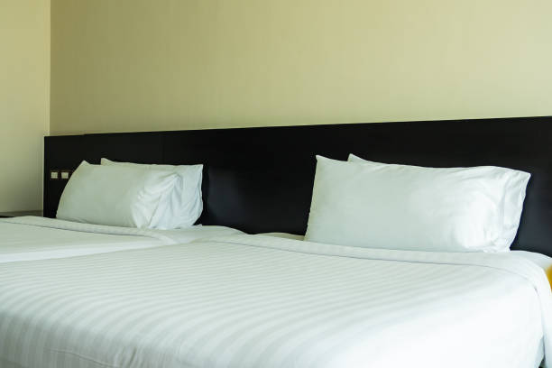 istock Pillow and blanket on bed with light lamp decoration interior 1186428666