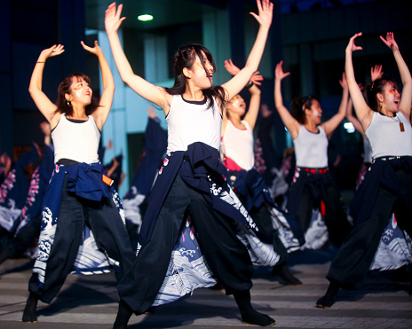 Tokyo, Japan - November 3, 2019: Japanese college student participants performing Yosakoi dancing at dusk in Odaiba. \nThe 18th \