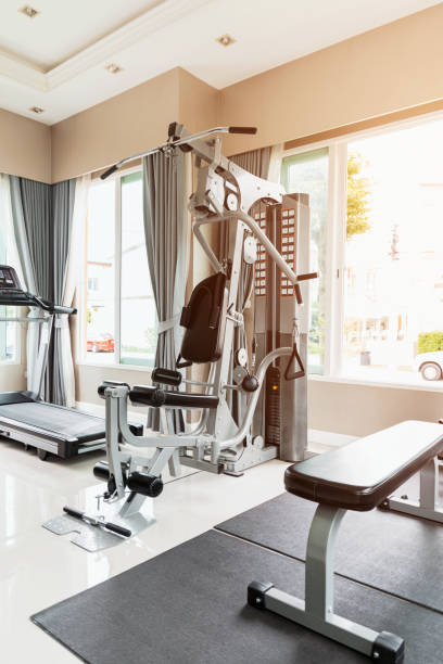 Empty gym or exercise room. Empty gym or exercise room has many types of equipment but no one uses them. exercise room stock pictures, royalty-free photos & images