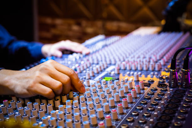 istock producer, sound engineer hands working on audio mixing console in recording broadcasting studio 1186443181