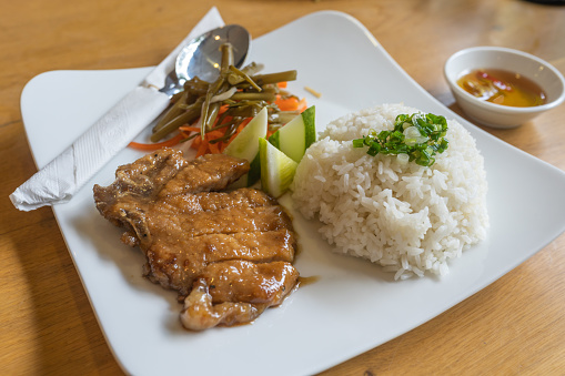 Vietnam gastronomy- delicious pork chop broken rice served with pickles