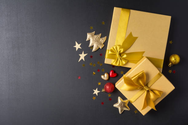 istock Golden gift boxes with shiny satin bow and glittering christmas tree toys 1186452749