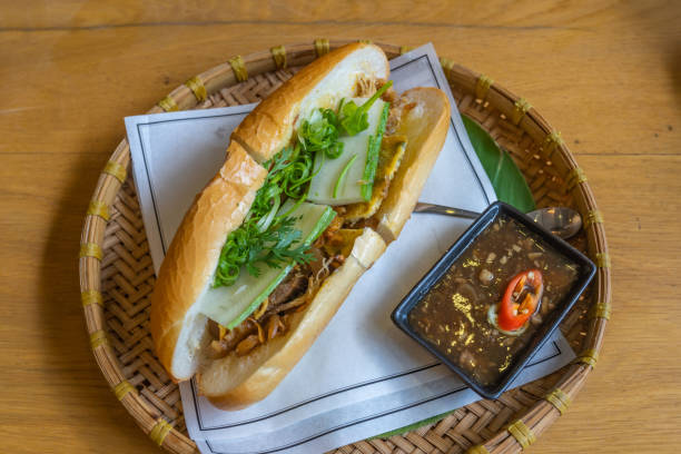 Delicious Vietnamese chicken banh mi served on traditional rattan tray stock photo