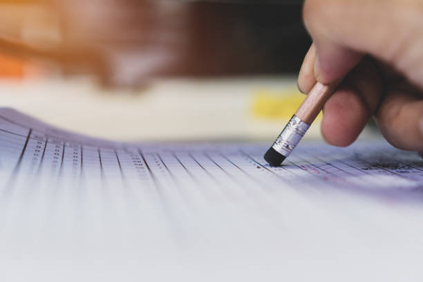 istock High school student holding pencil eraser for taking exams in examination room, writing answer aptitude test in classroom, view of having quiz competition for entrance to university, Education concept 1186453777