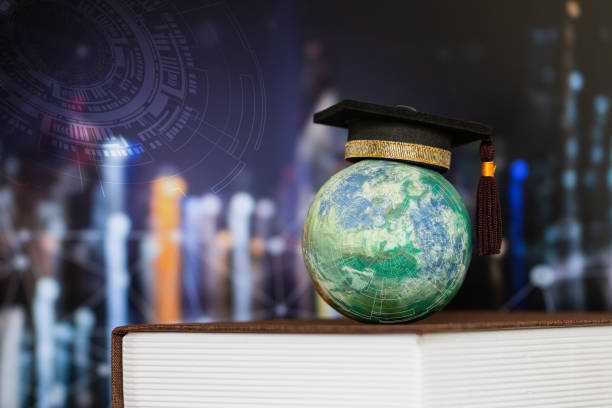 istock Education world knowledge ideas. Graduation cap on models paper craft earth globe on textbook, blur HUD graphic city network background. Concept of success business study abroad educational 1186455726