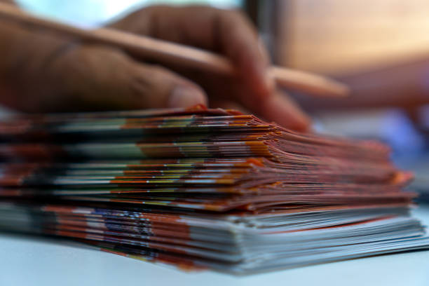 istock Business Documents concept : Businessman hands working in Stacks Brochures paper files for checking document achieves reports on busy work desk office 1186456442