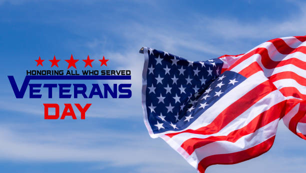 istock Happy Veterans Day with American flags on blue sky background. 1186462272