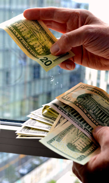 istock Stack of American Dollar bills against skyscrapers 1186463247