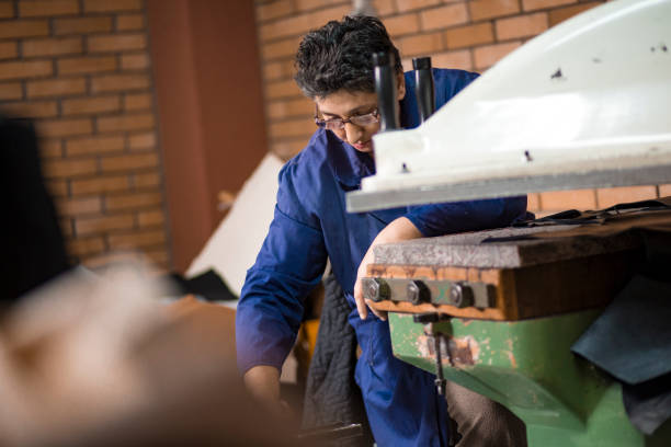 istock Shoemakers working in factory- teamwork 1186464163
