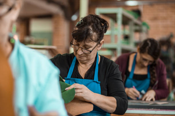 istock Shoemakers working in factory- teamwork 1186464211
