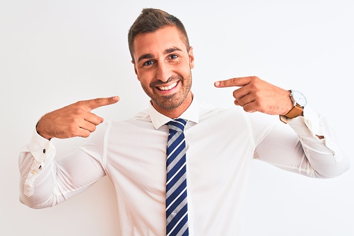Young handsome elegant business man over isolated background smiling cheerful showing and pointing with fingers teeth and mouth. Dental health concept.