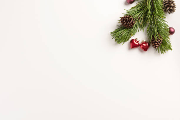 istock Christmas composition. Spruce branches with small hearts, on a white background. Christmas, winter concept. Flat lay, top view, copy space. 1186469269