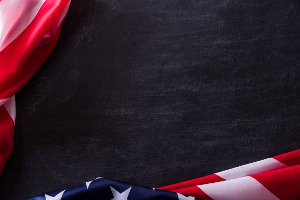 istock Happy Veterans Day. American flags veterans against a blackboard background. 1186469452