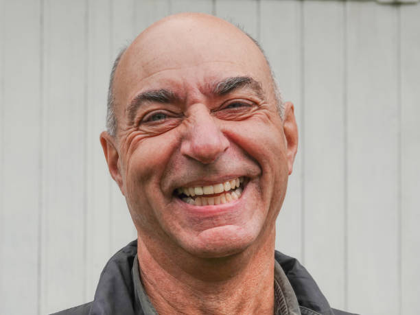 istock Handsome mature happy bald man smiling at the camera 1186469670