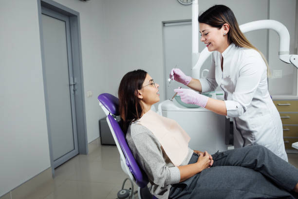 A woman is preparing for a dental examination. Woman having teeth examined at dentists. stock photo