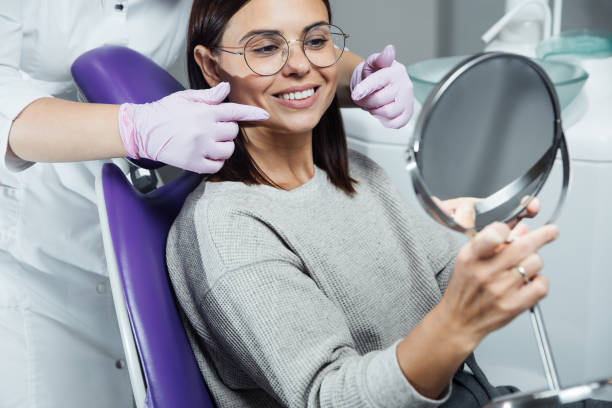 Beautiful woman at the dentist looking at her beautiful teeth. Dentist stock photo