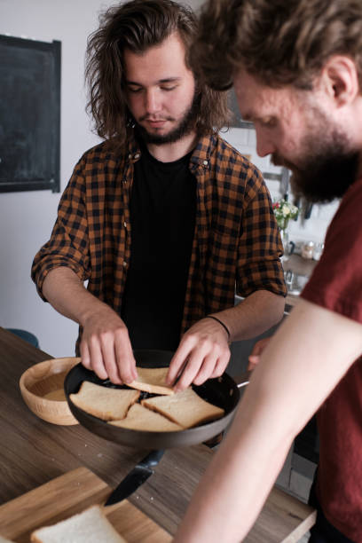 istock Friends cooking dinner together in the kitchen. 1186472237