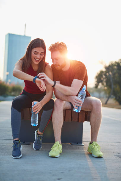 istock Modern couple making pause in an urban park during jogging / exercise. 1186472331