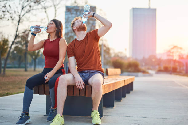 istock Modern couple making pause in an urban park during jogging / exercise. 1186472420