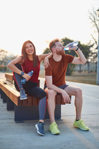 istock Modern couple making pause in an urban park during jogging / exercise. 1186472992