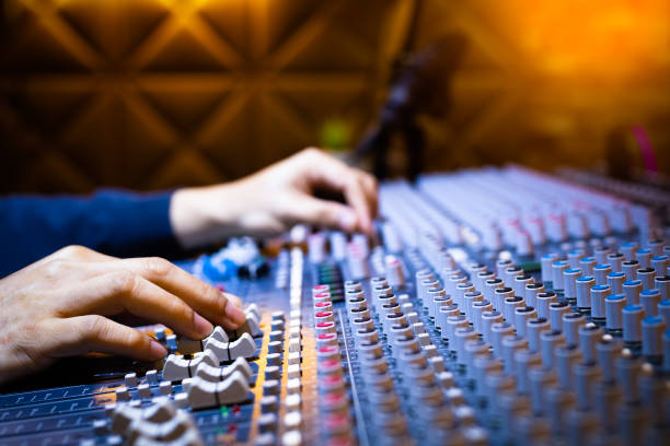 istock music producer, sound engineer hands working on audio mixing console on recording broadcasting studio. music production, post production, broadcasting concept 1186473184