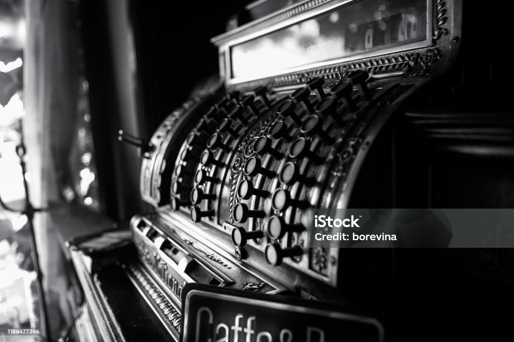 Black and white image of an old 19th century cash register. Selective focus on cashier buttons. Cash Register Stock Photo