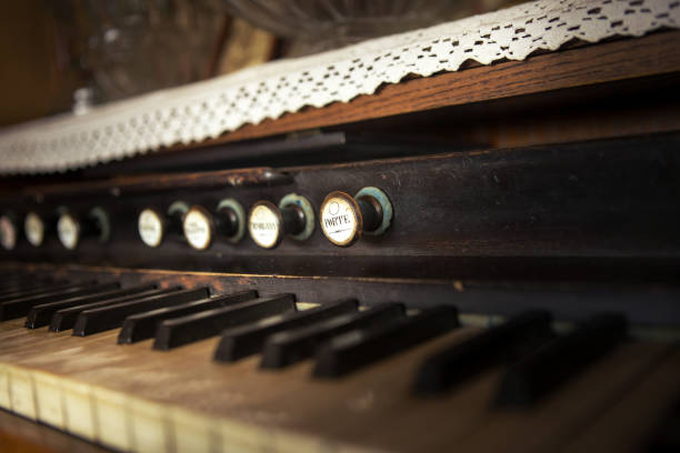istock Selective focus on a button on an old rustic piano. There are lace tablecloths on the piano. 1186477410
