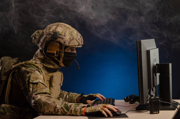 istock military in uniform sitting at a computer conducts cyber warfare 1186482303