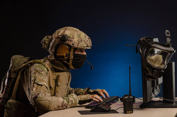 istock military in uniform sitting at a computer conducts cyber warfare 1186482313