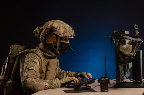 istock military in uniform sitting at a computer conducts cyber warfare 1186482314
