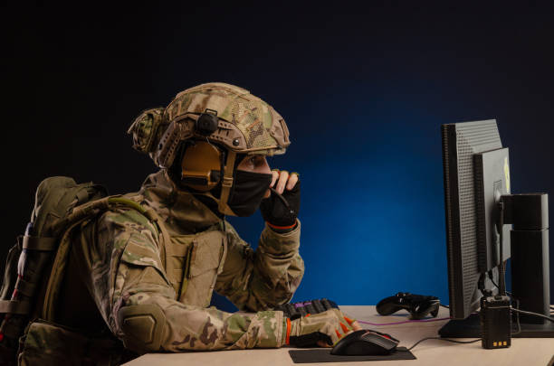 istock military in uniform sitting at a computer conducts cyber warfare 1186482315