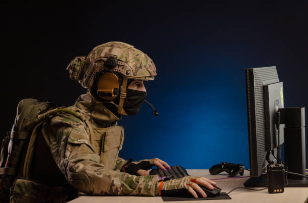 istock military in uniform sitting at a computer conducts cyber warfare 1186482317
