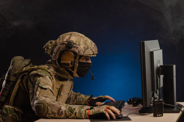 istock military in uniform sitting at a computer conducts cyber warfare 1186482319