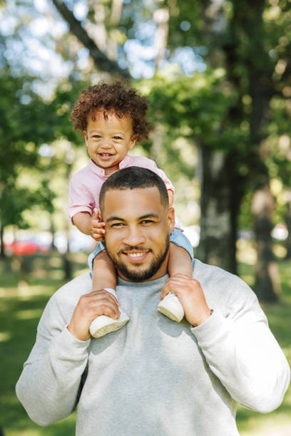 istock Young dad carrying cute son on his shoulders 1186483209