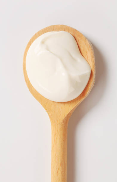 Creme fraiche on wooden spoon Creme fraiche on a wooden spoon wooden spoon stock pictures, royalty-free photos & images