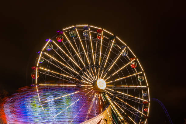 istock Two rides in motion in amusement park, night illumination. Long exposure. 1186483610